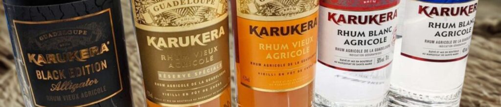 Bannière page marque Karukera : 5 bouteilles de rhum Karukera alignées avec de gauche à droite : Karukera Black Edition Alligator, Karukera Rhum Vieux Agricole Résèrve spéciale, Karukera Rhum Vieux Agricole, Karukera Rhum Blanc Agricole, Karukera Rhum Blanc Agricole